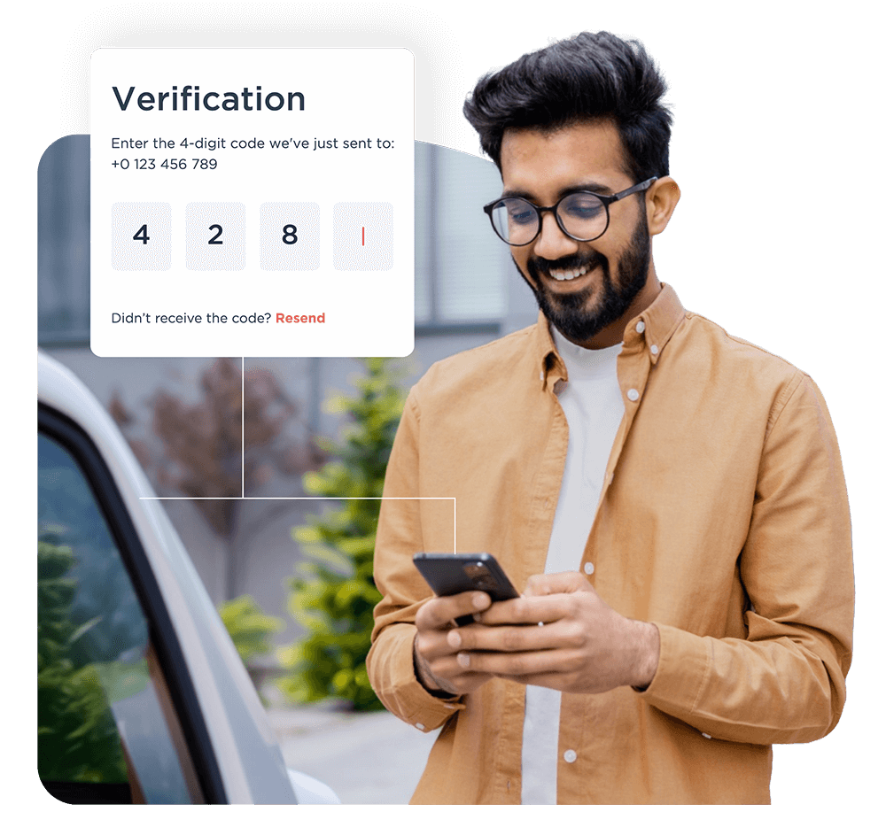 Man using a smartphone app to enter a verification code for keyless access to an electric vehicle