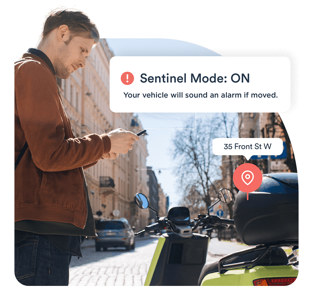 man using smartphone app to engage the anti-theft system for a moped